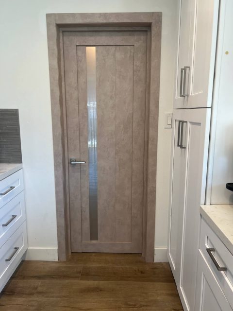 LV-21 beige concrete door between kitchen cabinets - warm texture against white cabinetry
