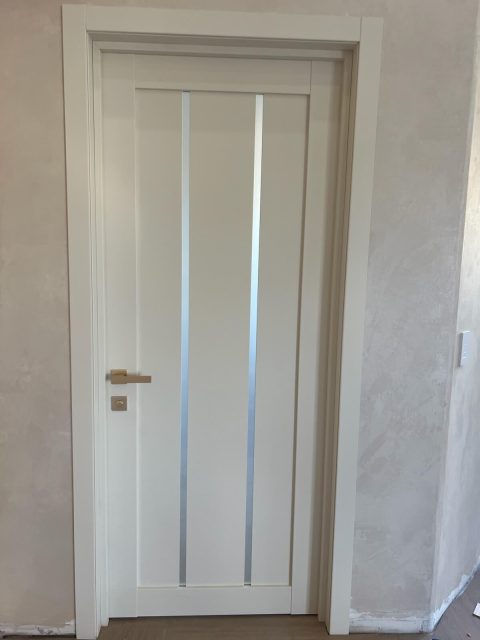 LV-04 Magnolia interior door with gold hardware installed in a luxury residential space